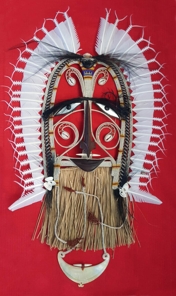 Torres Strait Islander ceremonial mask with white feather headdress, cowrie shells and pearl shell pendant